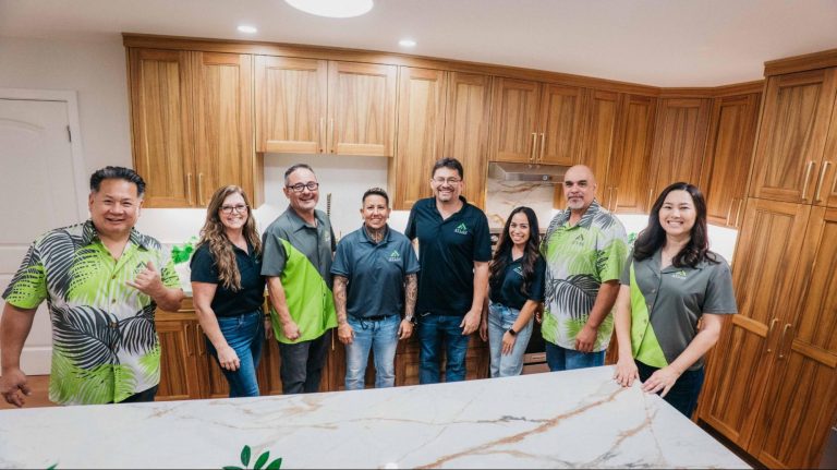 Open-concept custom home with modern kitchen, large island, hardwood flooring, and spacious living area designed through a design-build process.
